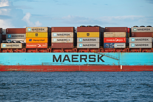 Charleston, SC, USA - August 20, 2023: the starboard side of the 3752 TEU Maersk container ship Willemstadt, showing dozens of 40-foot containers.