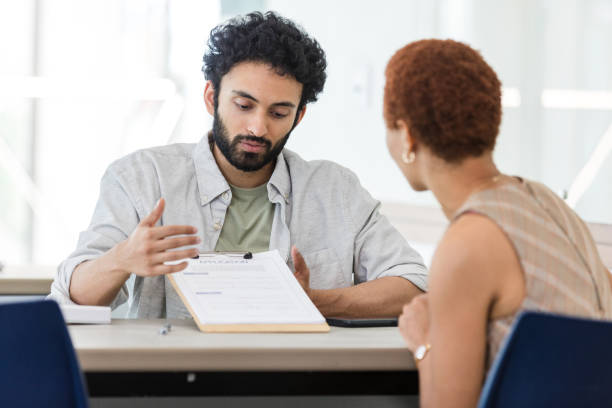 istock Male real estate agent explains application process to businesswoman 1629420376