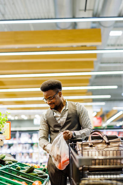 istock Smiling man shopping in supermarket 1629441016