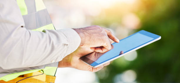 istock Man, architect and hands on tablet in city for communication, planning or networking on site. Closeup of male person, engineer or contractor working on technology for project plan in construction 1629441191