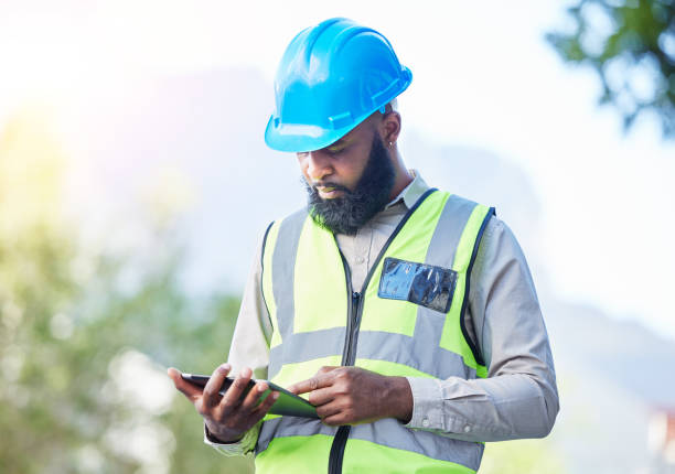 istock Construction worker, tablet and building inspection check with industrial employee with tech. African male person, professional and builder research with website and app for engineer project outdoor 1629441464