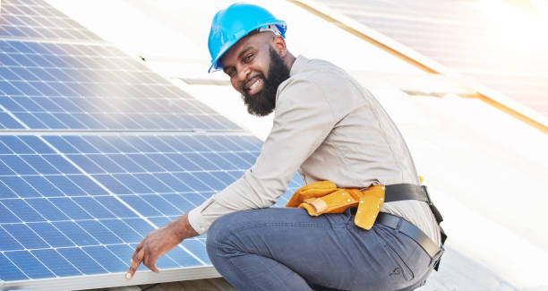 istock Black man, portrait and technician in solar panel installation on rooftop in city for renewable energy. Happy African male person, engineer or contractor working on roof in sun for electricity power 1629441541