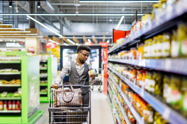 istock Man choosing groceries in store 1629443848