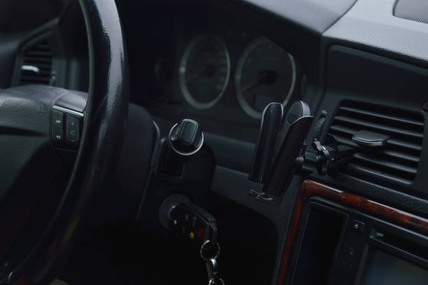 istock Dark car interior - steering wheel and dashboard. The car is modern inside. 1629446059
