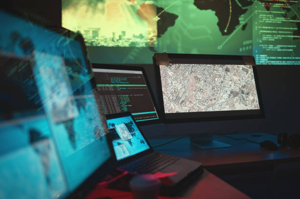 istock Computer, dark and monitor for global cyber security, government research or data capturing. Software, office and a desk with pc for world server, surveillance agency or information for analysis 1629459348