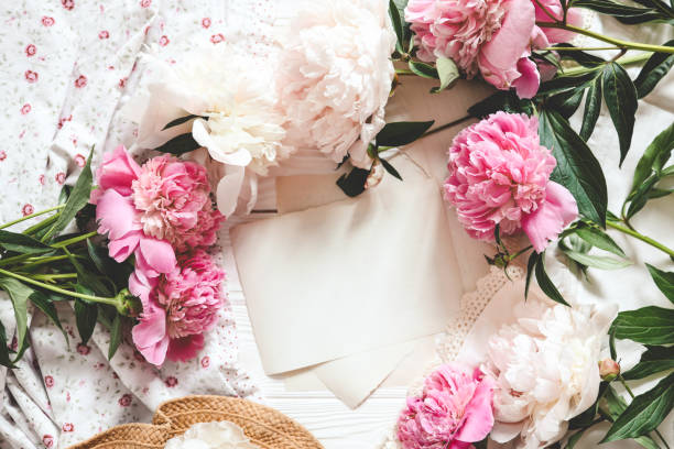 istock Letter template with place for your text and peonies, top view 1629467122