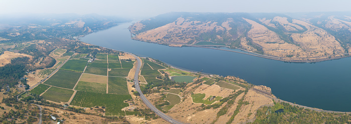The Columbia River Gorge is a federally protected scenic area forming the boundary between Washington and Oregon. The scenic area supports vineyards and is a popular area for outdoor sports.