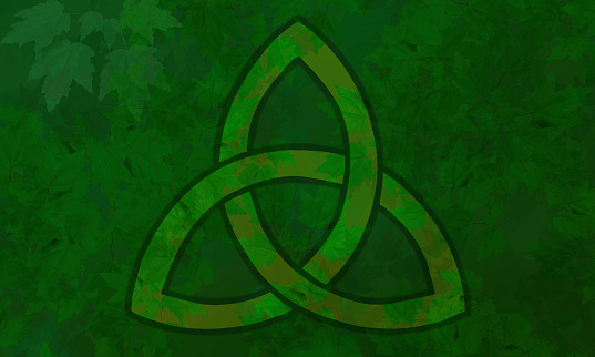 Trinity Celtic Knot on Green Leaves Background. Irish Love Knot, Celtic Love Knot, Trinity Knot, ancient Celtic symbol, triquetra.