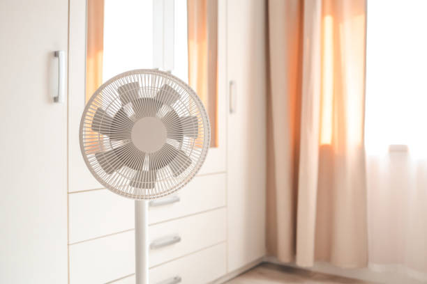 istock White desktop electric fan on light white room. Minimal concept with copy space 1629488014