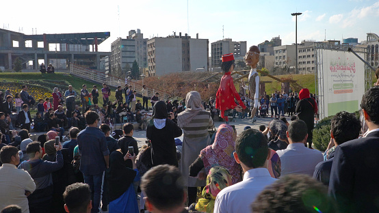 People gathering around and watching a Puppet show during the Nowruz holidays for the Persian New Year on August 16th, 2017