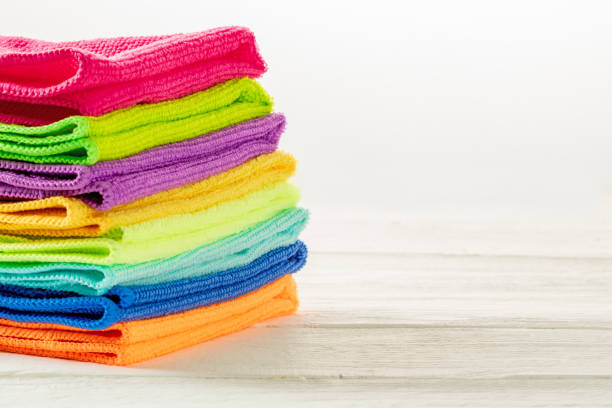 istock Stack of kitchen microfiber towels in bright colors on a white wooden background 1629507004