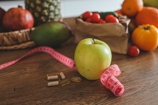 fresh apple with measuring tape. diet concept, loss weight