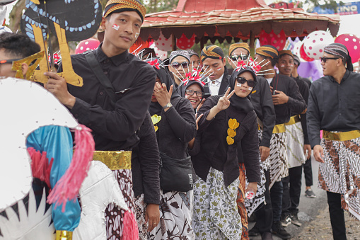 Cilacap, Indonesia august 21, 2023 : a man and several women wearing traditional Javanese clothes in order to take part in the carnival celebration of the independence of the republic of Indonesia