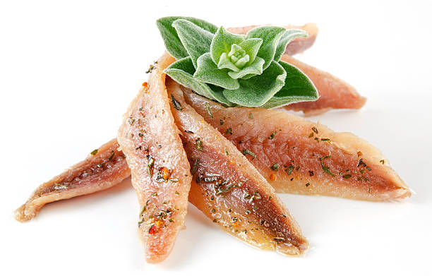 anchovies on white with spice and oregano anchovies on white with spice and oregano kipper stock pictures, royalty-free photos & images