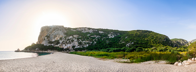 Scenic cliffs near sunny turquoise blue sea shore on a bright clear day in Gialos beach, Lefkada island, Ionian sea coast, Greece.