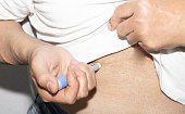Male patient injecting insulin. Insulin injection pen or insulin cartridge pen for diabetics.