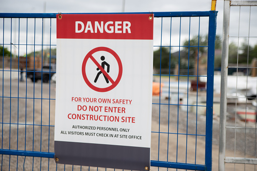 A warning sign at the construction site to restrict people's entry for only authorized personnel only with strict covid prevention protocol.