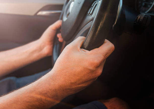 istock Hands of car driver on steering wheel 1629539654
