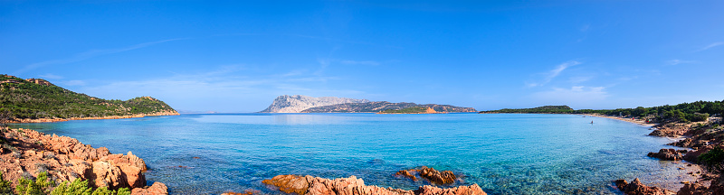 Clear amazing azure coloured sea water with granite rocks in Capriccioli beach, Sardinia, Italy.