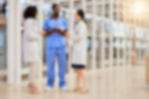 Blurred hospital, doctors and team of nurses consulting for medical services, advice and expert management. Defocused group of healthcare employees meeting for wellness, support or planning in clinic