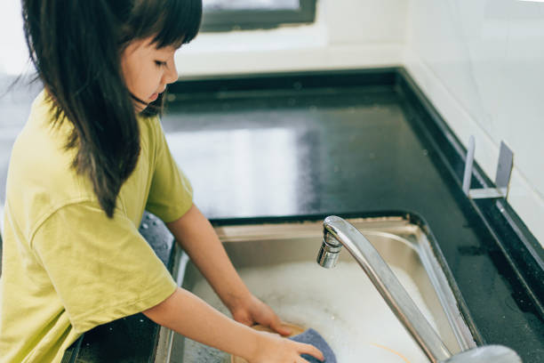 istock The girl is washing dishes 1629557918