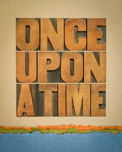 once upon a time opening phrase - storytelling concept, word abstract in vintage letterpress wood type against art paper