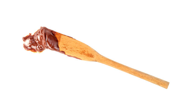 istock Chocolate spread with wooden spatula isolated on white background 1629566562