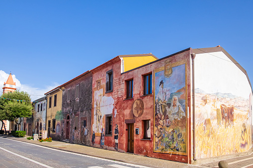 Valparaiso, Chile - February, 2020: City street in Barrio Bellavista district with colorful houses and walls decorated with graffiti. Typical street in Valparaiso with street art leading down to Ocean