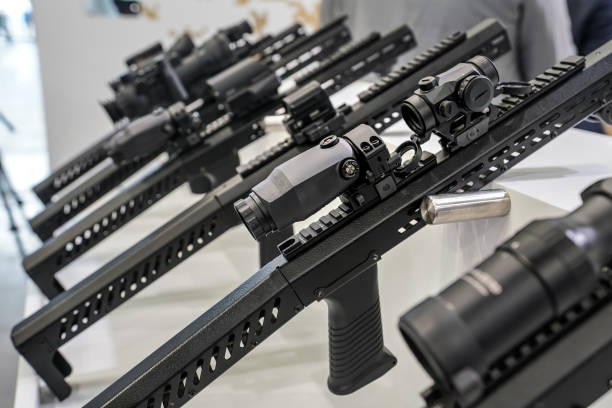 istock Black shooting scope optics mounted on metal bar displayed at weapons exhibition fair, closeup detail to adjustment knobs 1629577313