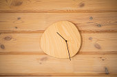 Timeless Simplicity: Wooden Wall Clock Adorning a Textured Wall