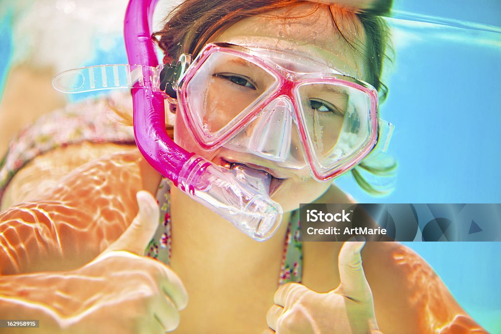 Snorkeling underwater Little girl happly snorkeling Aquatic Sport Stock Photo