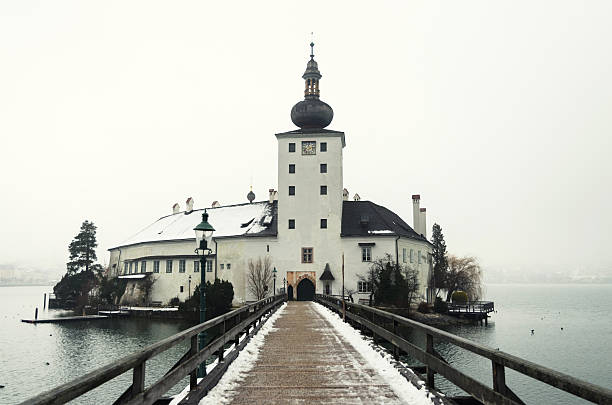 Bridge to Seeschloss Ort Wonderful capture of the old church Seeschloss Ort in Gmunden on a cold and snowy January morning. The area of Salzkammergut is a world heritage site. The Seeschloss was also royal residence of Adam von Herberstorff, who died September 1629 in this building. Since 1995, the Seeschloss is a public building. seeschloss stock pictures, royalty-free photos & images