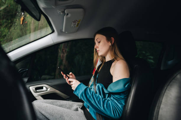 istock Young woman using the mobile phone in the car 1629590463