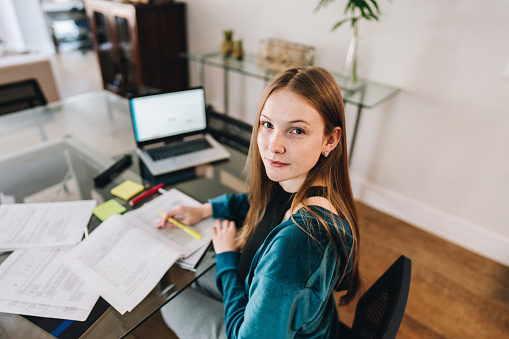 Portrait of a young woman studying at home