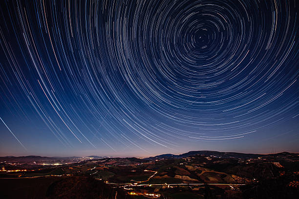 Starry Night on the Tuscan hills Beautiful track star image during a night in Tuscany. Trajectories of aircraft and shooting stars in the sky. Long exposure for trails of stars. meteorite photos stock pictures, royalty-free photos & images
