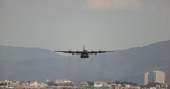 The military transport plane take off on the airport runway
