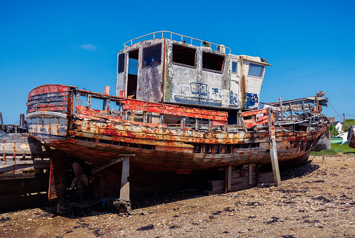 Destroyed fishing boat against a clear blue sky. With copy space. Shot with a 35-mm full-frame 61MP Sony A7R IV.
