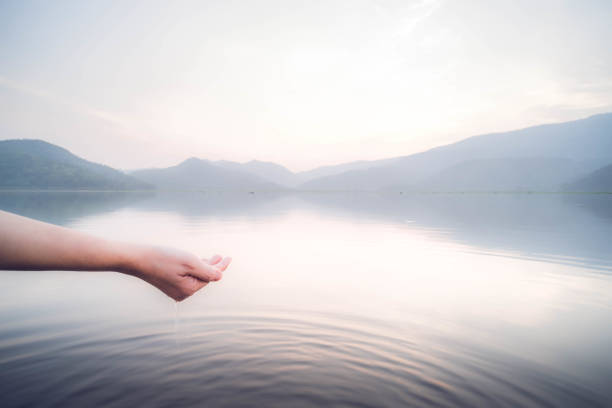 Person Taking Raw Unfiltered Water From A Lake By Hands
