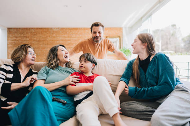 istock Happy family relaxing on sofa and talking at home 1629608585