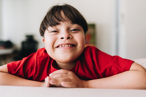 Portrait of a boy with down syndrome at home