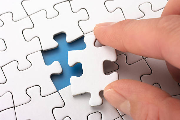 istock Person fitting the last puzzle piece. 162961210