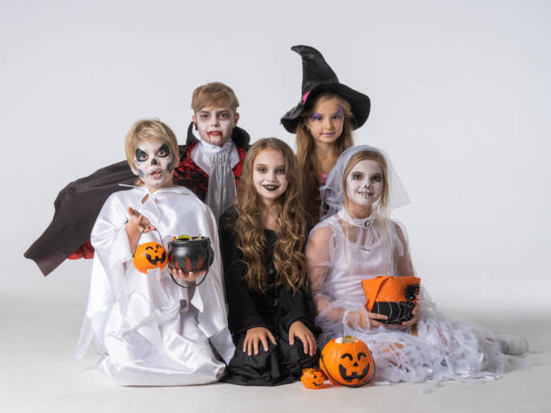 istock Children in Halloween costume on white 1629615786