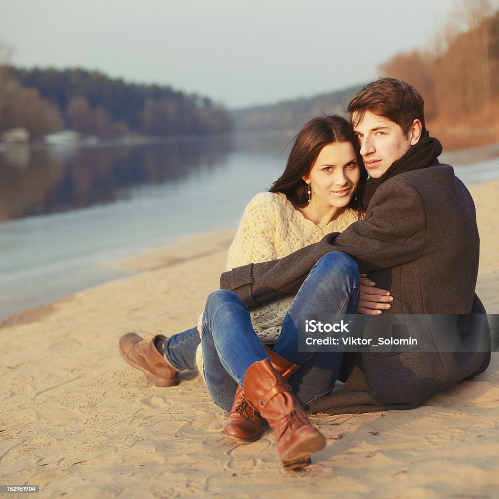 Portrait of young happy couple Portrait of young happy couple. Young handsome man embracing young beautiful brunette outdoor in the park. Adult Stock Photo