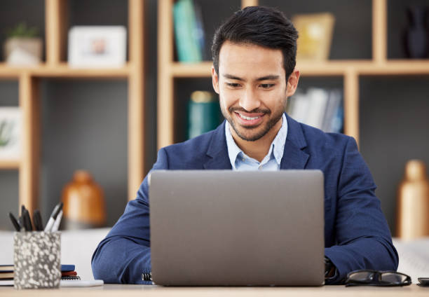 istock Man in office with laptop, smile and typing email, proposal or writing online report networking at startup. Happy businessman, computer and administration work for editing, copywriting or web search. 1629630994