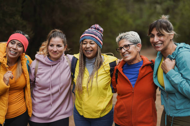 istock Multiracial women having fun together during trekking day while hugging each other and smiling in front of camera 1629631534