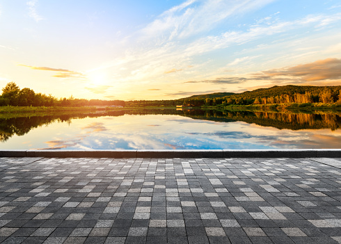 Empty brick road beside the lake