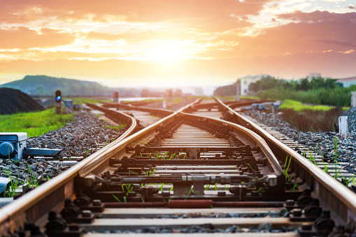 Railway track in the evening in sunset. Panoramic view on the railroad switch.