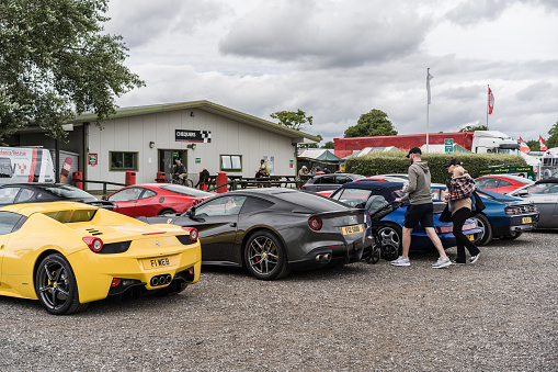 Tarporley, Cheshire, England, July 30th 2023. Yellow Ferrari 458 Spider and grey F12 Berlinetta at a supercar meet.