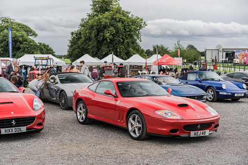 Tarporley, Cheshire, England, July 30th 2023. Red Ferrari 575M at a supercar meet, automotive lifestyle editorial illustration.