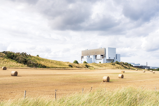 A harvested field in front of Torness nuclear power station in East Lothian, Scotland.
